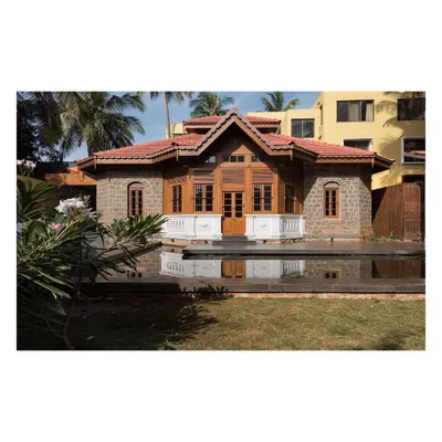 The restored colonial building at the KLE Centenary Museum, viewed across the lotus pond. Our intervention preserved the original stone and timber facade while integrating it into a newly designed plaza that serves the public.