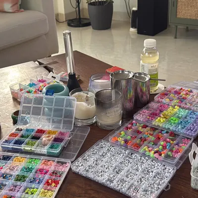 A look at my coffee table takeover before a ParaDisco event. I personally make hundreds of custom Kandi bracelets to give out, making sure every detail is filled with love.
