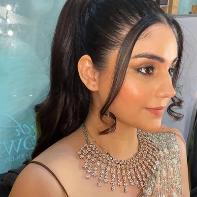 A clean and modern party look is always in style. Here, the focus is on flawless skin, sharp winged eyeliner, and a sleek ponytail, making it a perfect choice for a cocktail party or a formal dinner.