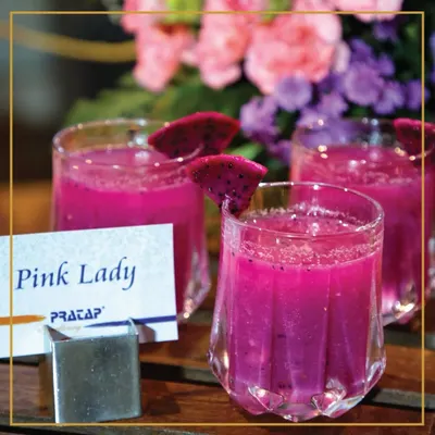 Sip into something fabulous with our "Pink Lady" mocktail. This vibrant dragon fruit drink is a delightful blend of elegance and flavor, perfect for welcoming your guests.