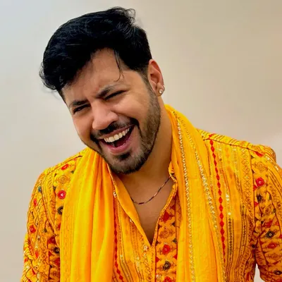 A candid laugh in a bright yellow mirror-work kurta, perfect for a vibrant Haldi or Mehendi ceremony.