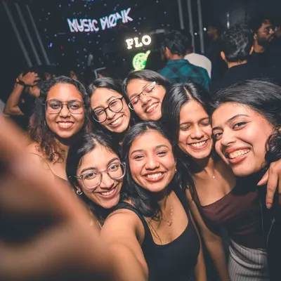 A group of friends taking a happy selfie on the dance floor. My goal is to create the perfect backdrop for your memories.
