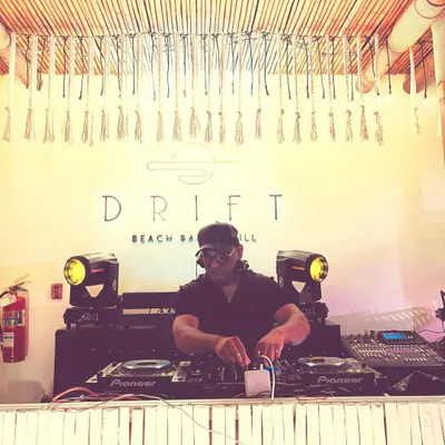 On the decks at Drift Beach Bar & Grill in Thailand for a wedding event. This shot highlights my experience playing at premier international venues and adapting my sound to fit a tropical, upscale vibe.