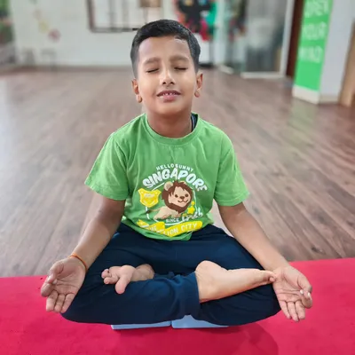 Finding a moment of calm. I teach simple meditation and breathing techniques, like this seated Padmasana (Lotus Pose), to help children manage their energy and improve their focus after a busy day.