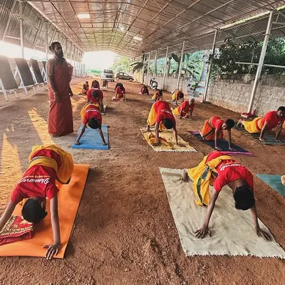 Physical conditioning is essential for an archer. Students engage in yoga asanas like the downward-facing dog to build strength, flexibility, and endurance, preparing the body for the rigors of Dhanurvidya.
