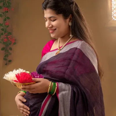 This portrait captures the essence of a traditional Maharashtrian baby shower, or dohale jevan. The mother-to-be, dressed in a beautiful saree, holds a plate of flowers, symbolizing blessings and fertility.
