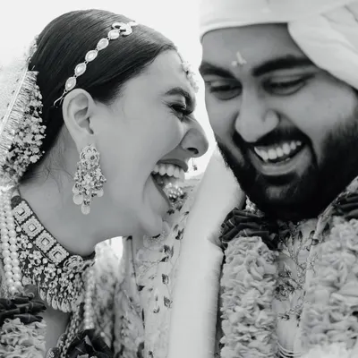 The purest form of joy captured in a timeless black and white frame. This candid photograph of the couple's unrestrained laughter during their wedding ceremony is a perfect example of the unscripted, real moments I strive to capture.