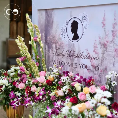"Lady Whistledown welcomes you." This elegant sign, surrounded by a lavish arrangement of roses, orchids, and tuberoses, set the perfect tone for a sophisticated Bridgerton themed baby shower.