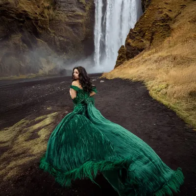 A breathtaking shot of Shree in Iceland. The emerald green Gavin Miguel gown with its long, feathered train creates a stunning visual against the raw, natural landscape.