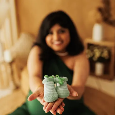 The tiniest shoes, waiting for the tiniest feet. This is a classic detail shot that speaks volumes about the love and anticipation you feel.