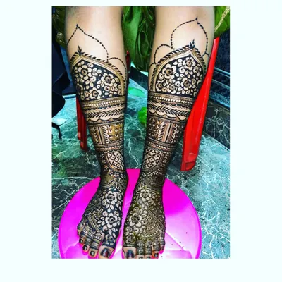 A stunning example of heavy bridal mehendi for the legs. This design features intricate floral and geometric patterns that provide full coverage.
