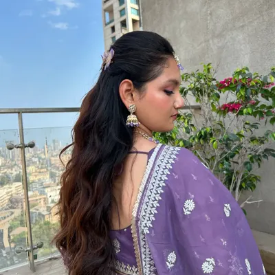 This effortless half-up hairstyle with soft waves is perfect for when you want a look that's special but not overly formal. The butterfly clips add a whimsical touch.