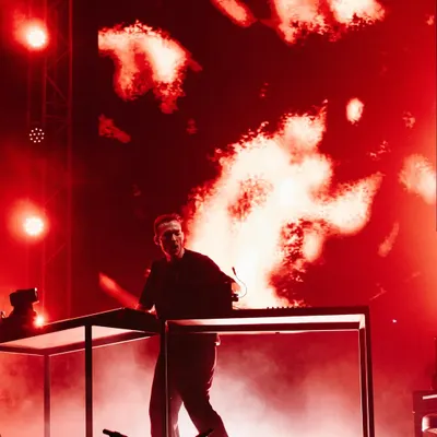 Ben Böhmer performs in a haze of red smoke and light, creating a fiery and intense atmosphere for his melodic techno set.