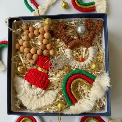 My curated Christmas ornament gift box is perfect for friends and family. It includes a macrame reindeer, Santa, rainbow, and wooden bead garland, all ready for the tree.