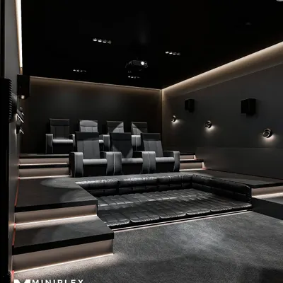 A side view of our 'Shadow Luxe' project, highlighting the clean lines of the tiered seating platform with integrated step lighting. The design ensures every seat has an unobstructed view, while the dark, non-reflective surfaces minimize light bleed and enhance on-screen contrast.