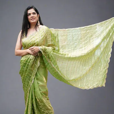 A full view of our lightweight and pocket-friendly party-wear organza tissue saree in a lovely lime green. The delicate sequins and scallop edging add just the right amount of glam.