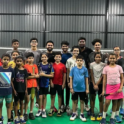 A full house with our badminton family. This group photo captures the diverse community we've built, with beginner kids, intermediate players, and coaches all sharing the court.