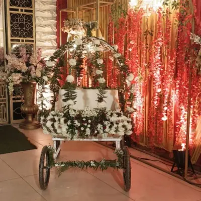 I believe the birthday star deserves a grand entrance. This is one of my custom decorated royal carts, adorned with fresh flowers and foliage, ready to make a child's 5th birthday entry feel special.