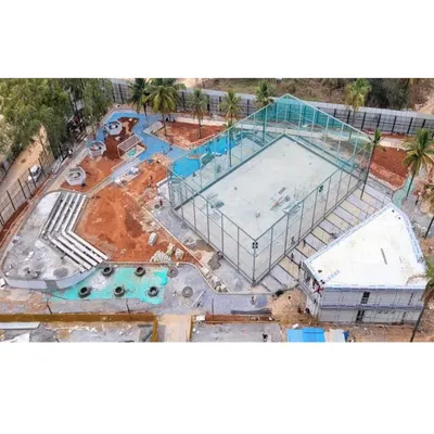 An aerial shot of the Vaishnavi Tech Square site during construction. This view shows the foundational layout of the sports court, amphitheater, and pathways, giving a sense of the project's scale.