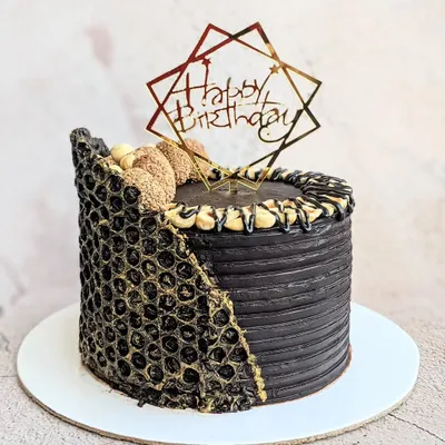 Chocolate is happiness you can eat. This decadent Ferrero Rocher cake is covered in dark chocolate ganache and features a unique chocolate collar made using a bubble wrap mold for texture.