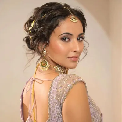 This modern, tousled updo is one of my most requested styles. It offers a soft, romantic texture that looks effortlessly chic and is perfect for framing the face and showing off statement earrings.