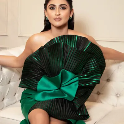 A direct, stunning shot of Krystle D'Souza. The makeup features a flawless base, contoured features, and a sharp winged liner that holds its own against the dramatic silhouette of her gown.
