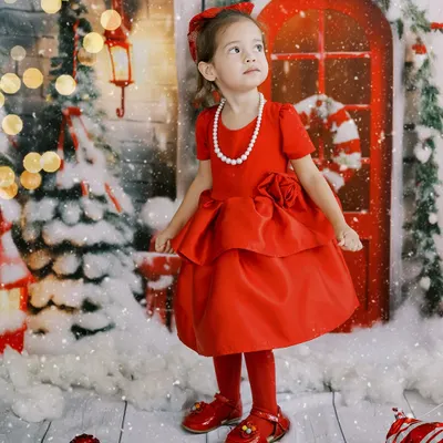 Believing in the magic of the season. This little girl in her beautiful red dress is ready for Christmas. These photos become treasured memories long after the season passes.