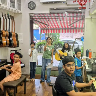 Here’s a look inside our studio where the magic begins. Our Prayer Song Band is in full rehearsal mode, with students on vocals, guitar, and keyboards all working together. We provide a fully equipped space and expert coaching to help our bands find their unique sound.