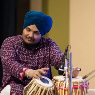 A focused moment during a live concert. This photo captures the concentration required to perform on stage, connecting with the music and the audience.