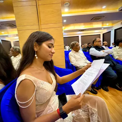 Before the energy and action, there's always a moment of quiet preparation. Here I am reviewing the event flow and my script to ensure everything runs smoothly and professionally.