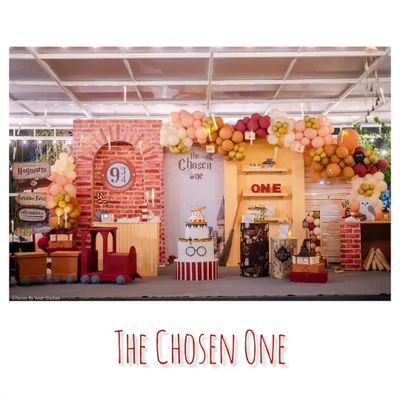 A magical Harry Potter setup for 'The Chosen One'. This wide shot shows our custom Platform 9 3/4 backdrop, a mini Hogwarts Express, and balloon garlands in house colors.