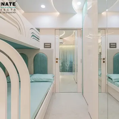 A unique kids' room designed to maximize space. This room features custom-built bunk beds with wave-like cutouts and individual headboards, creating cozy, personal nooks for each child. The mirrored wardrobe doors make the narrow room feel much larger.