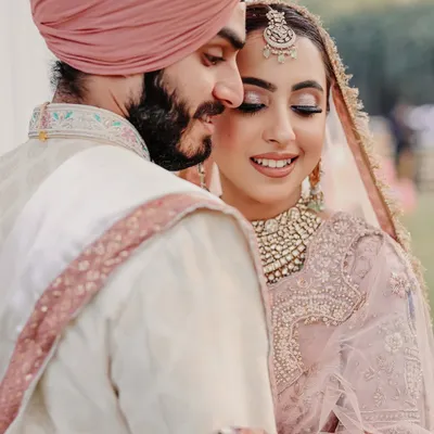 An intimate and heartfelt portrait of a Sikh couple. The soft smiles and gentle embrace capture the beautiful connection they share on their wedding day.