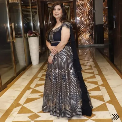 A full-length view of this exquisite black and silver gown, showcasing its beautiful flare and intricate pattern. It's a perfect example of a premium designer dress for a grand evening affair.
