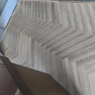 This is a modern herringbone pattern flooring I installed. It's a stylish and durable choice for living rooms, bedrooms, and hallways, giving the space a sophisticated look.
