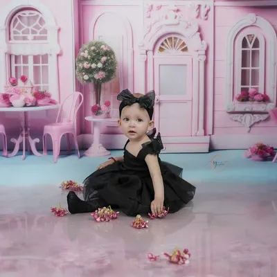 A quiet moment in her pink dollhouse world. This shot captures the dreamy, imaginative quality of our themed sessions for toddlers.