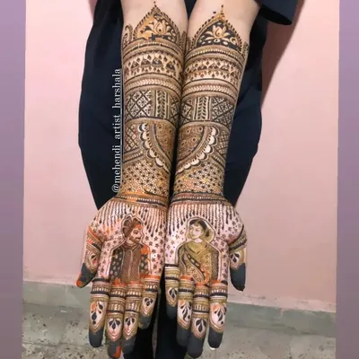 A complete bridal mehendi with detailed portraits of a Maharashtrian couple. The design extends to the elbows, featuring traditional motifs that complement the bride and groom figures on the palms.