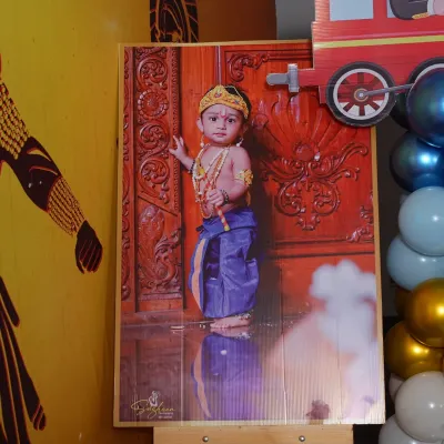 A personalized photo standee featuring the birthday boy dressed as Little Krishna. This custom prop adds a unique and personal touch to the event decor, perfect for photo opportunities.