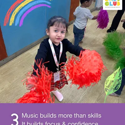 Music does more than just build skills; it builds focus and confidence. This little one is fully engaged with her pom-poms, learning to follow the rhythm and participate in a group setting.
