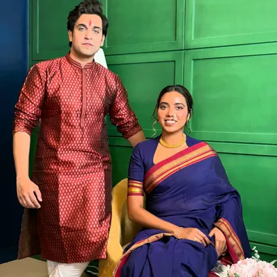 A professional portrait from a brand shoot featuring a classic Marathi look. I'm posing with my co-model, creating a scene that feels authentic and culturally rich, perfect for festive campaigns.