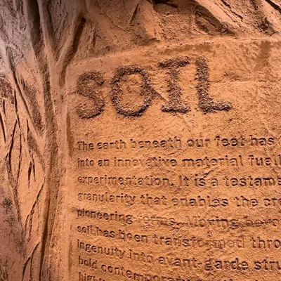 We believe material is a medium for storytelling. This close-up of our 'Soil' installation for ColourNext reveals text debossed into an earthen texture. It highlights our focus on the tactile and sensorial, transforming a raw material into an artistic and communicative surface.