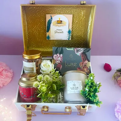 Experience true luxury with our stunning white and gold metal trunk. This hamper is curated with premium candles, chocolates, and nuts for an opulent Diwali gift.