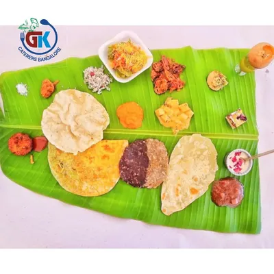 The Famous 50-50 Holige: Our signature fusion sweet. This holige (obbattu) is half traditional dal filling and half rich chocolate, offering two amazing tastes in one. It's a must-try.