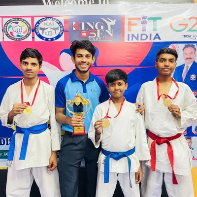 Standing proud with my champions and our team trophy. Each medal around their necks represents countless hours of hard work and dedication in our karate classes.