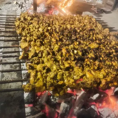 This is how we cater for a large crowd. Hundreds of chicken tikka pieces being grilled at once over hot coals.