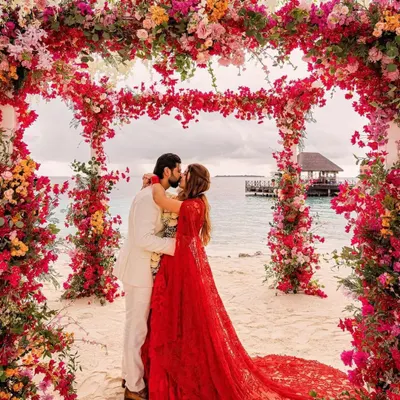 Being a part of this magical beach wedding, featured in Vogue, was an absolute honor. Despite the rain, the bride was radiant in a bold red gown. Her makeup was designed to be weather-resistant and glowing.