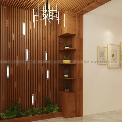 We transformed this foyer into a warm and inviting entrance using polished wooden rafters. The design includes integrated wall lights, a corner display shelf for plants, and a dramatic modern chandelier.