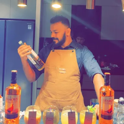 Here I am preparing a smoked whisky cocktail using The Famous Grouse. The technique involves using a Flavour Blaster to infuse the drink with an aromatic cloud, adding a dramatic flair to our mixology services.