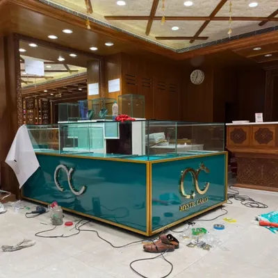 The final setup for the Mystic Carat jewelry store, featuring a custom-built teal and gold counter. The design combines luxury materials and strategic lighting to create a high-end retail experience that makes the products shine.