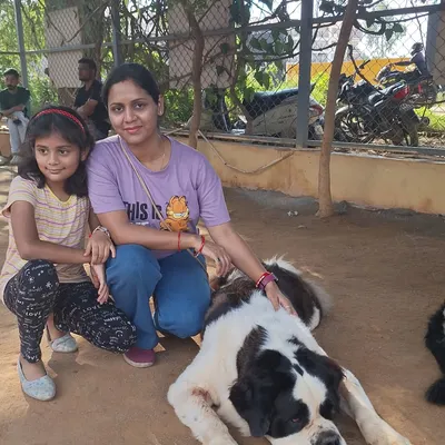 A mother and daughter posing with our gentle St. Bernard, a perfect family outing.